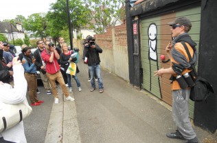 Stik explaining his rendition of Pieter Coecke Van Aelst's Adam and Eve (The Fall of Man)