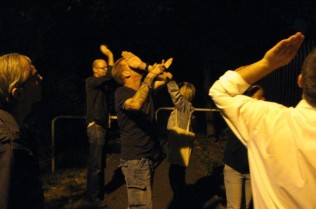 Shielding our eyes from the streetlights to see the bats better
