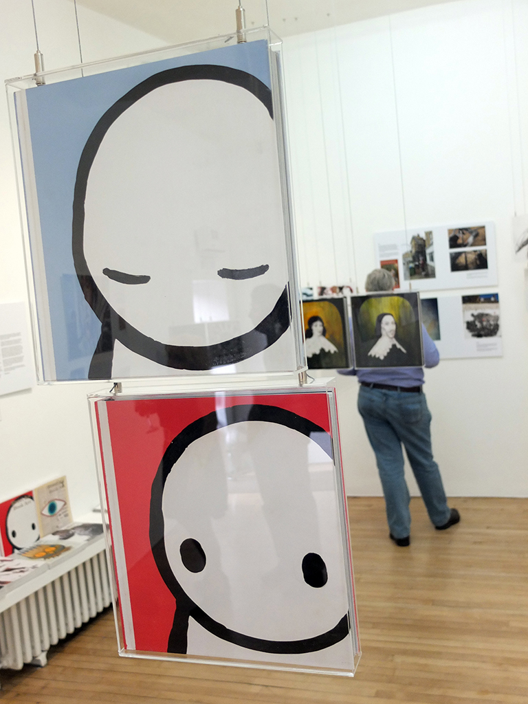 Books illuminated by Stik and System at Street Art Book Art show.  Photo by APHQ